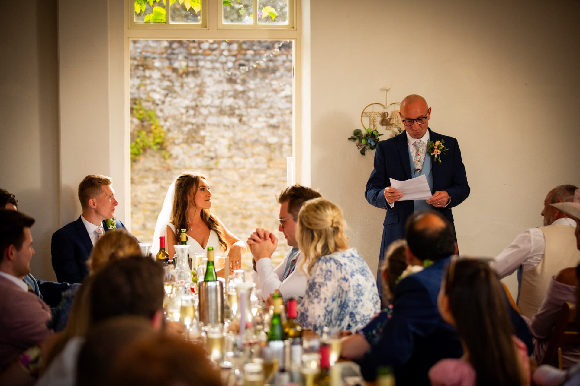 Father of the bride giving a speech beside the top table at Bignor Park