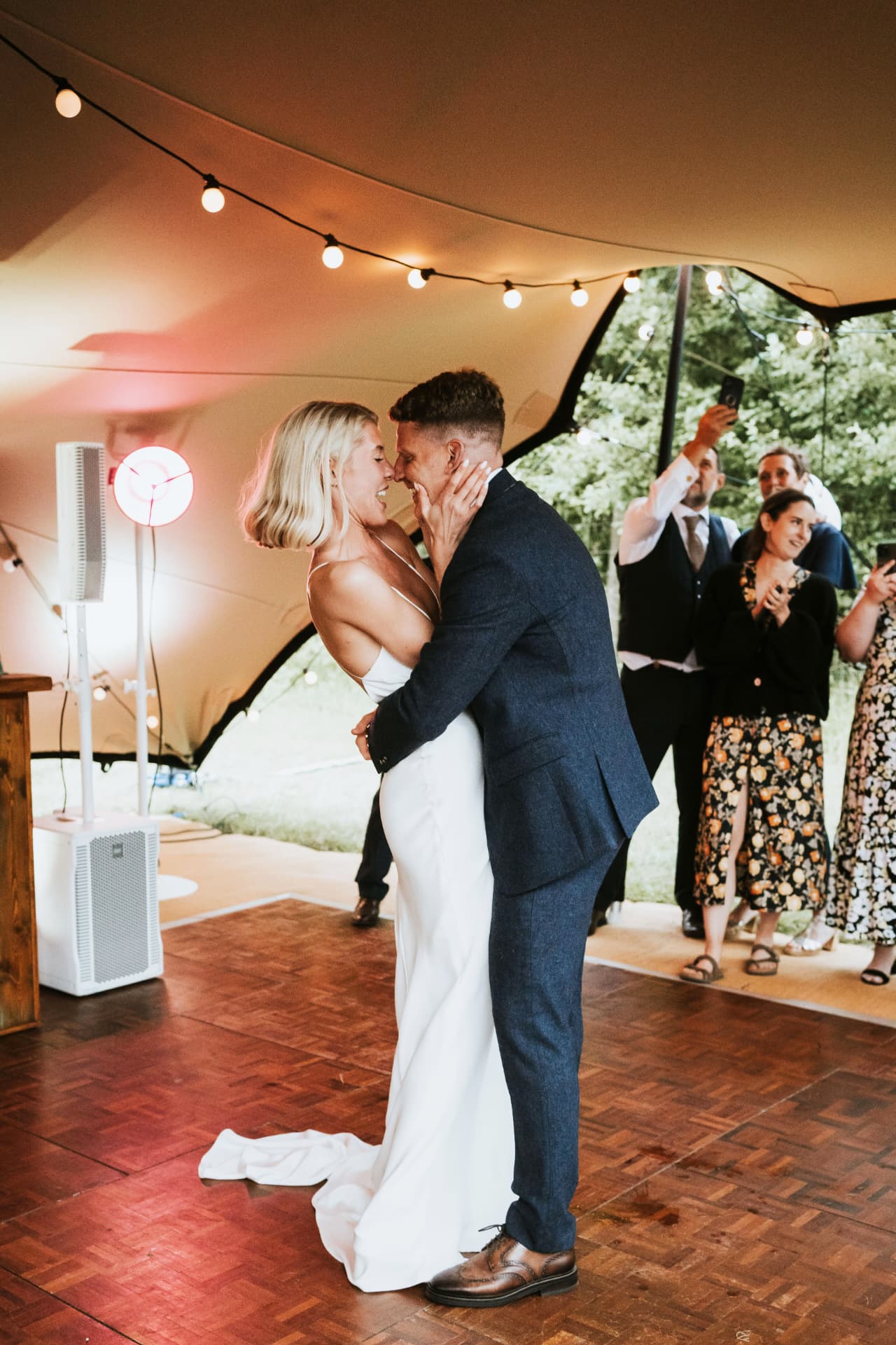 Bride and groom sharing their first dance under a stretch tent at Wiston Estate
